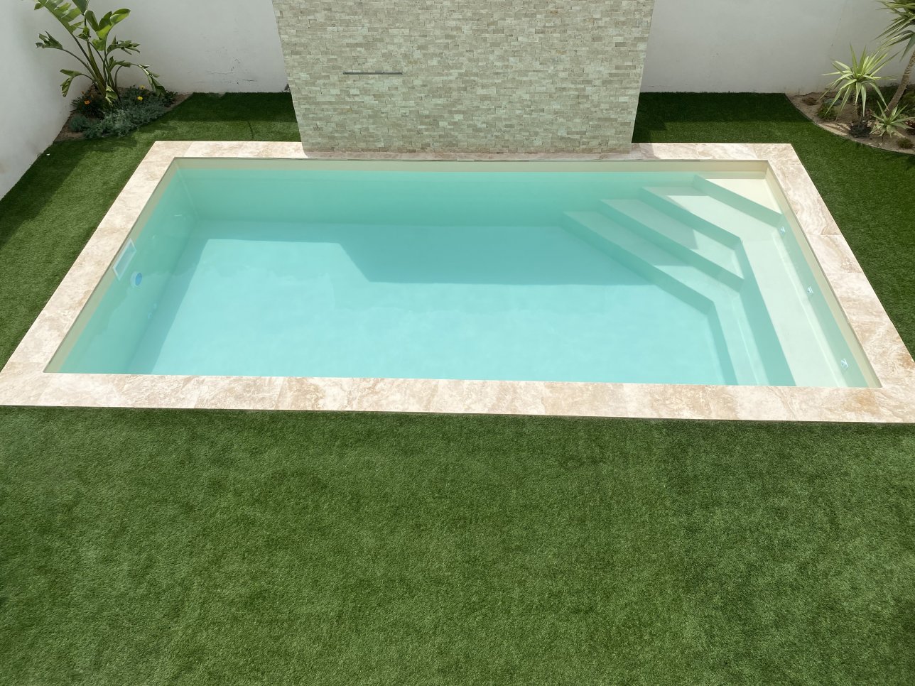 Photo piscine beige avec l'escaliers dans l'angle - Photo d'une piscine coque
